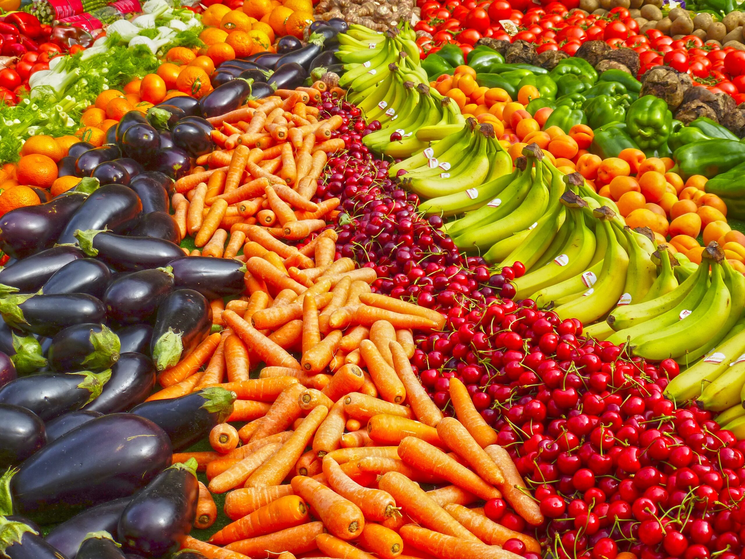 an array of fruits and vegetables stacked next to each other